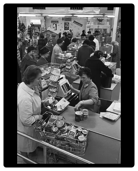 Customers at the checkout counter of the Nottingham Co-Op supermarket. 1st May 1963
