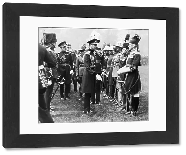 King George VI seen here presenting Coronation medals to members of the Oversea