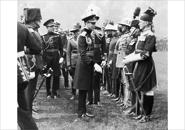 King George VI seen here presenting Coronation medals to members of the Oversea