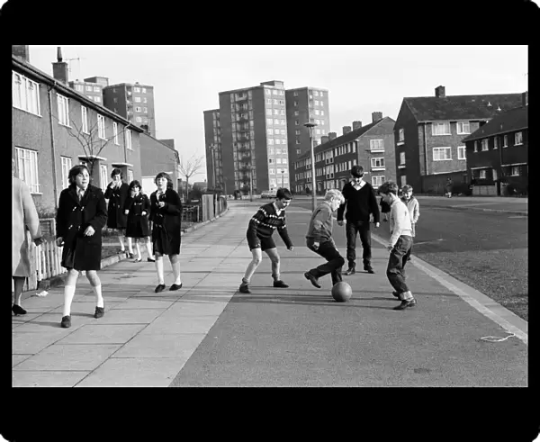 A typical street in Kirkby, Liverpool. Boys playing football in the street