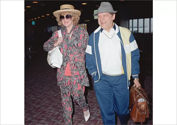 Actor David Jason and girlfriend Myfanwy Talog leaving Heathrow Airport for a holiday in