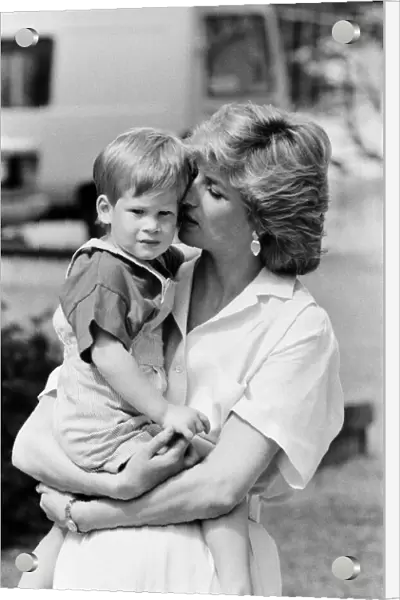 HRH Princess Diana, The Princess of Wales holds her young son Prince Harry on holiday in