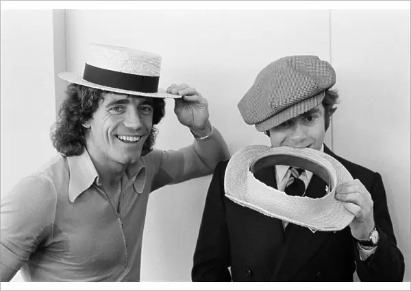 Kevin Keegan in a straw boater hat and Elton John in his own hat