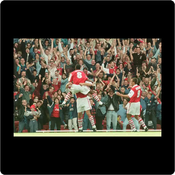 Dennis Bergkamp celebrates his first ever goal for his new club Arsenal