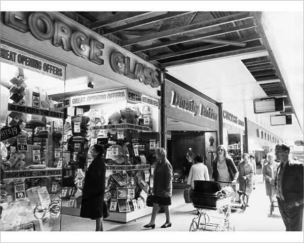 Shoppers browsing through shop windows at the new Salford City Shopping Centre