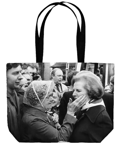 Conservative Party leader Margaret Thatcher receives an affectionate pat on the cheek