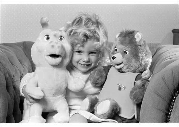 A young girl with soft toys, left a Teddy Ruxpin toy. 21st October 1986