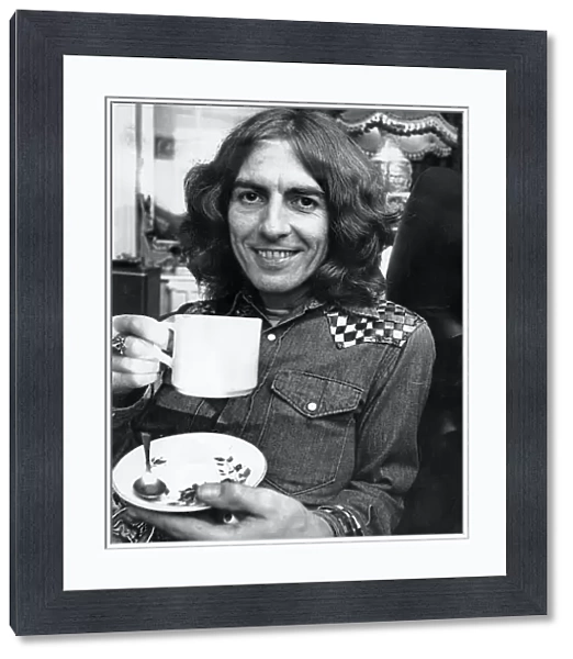 George Harrison, once a member of The Beatles, pictured having a cup of tea in Warrington