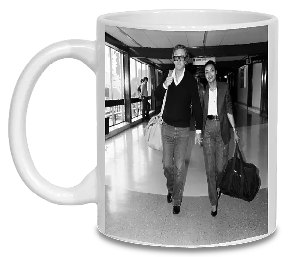 Actor Michael Caine and his wife Shakira arriving at Heathrow Airport from Barbados