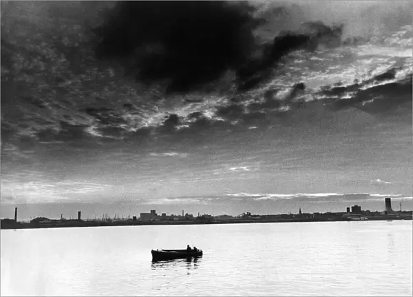 The Mersey Millpond. As night draws in, a lonely boat makes its way along a peaceful