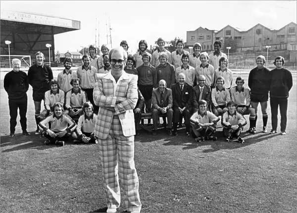 Elton John poses with his team of players and staff of Watford Football club