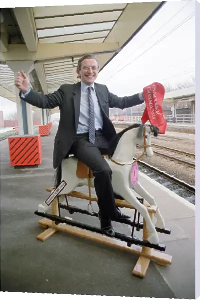 Employment Secretary, Norman Fowler, on a rocking horse