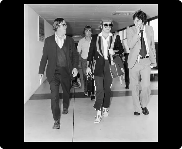 Elton John, departs London Heathrow, heading for Los Angeles. 26th June 1977