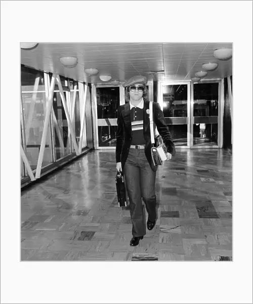 Elton John leaving Heathrow Airport for Los Angeles. November 1977