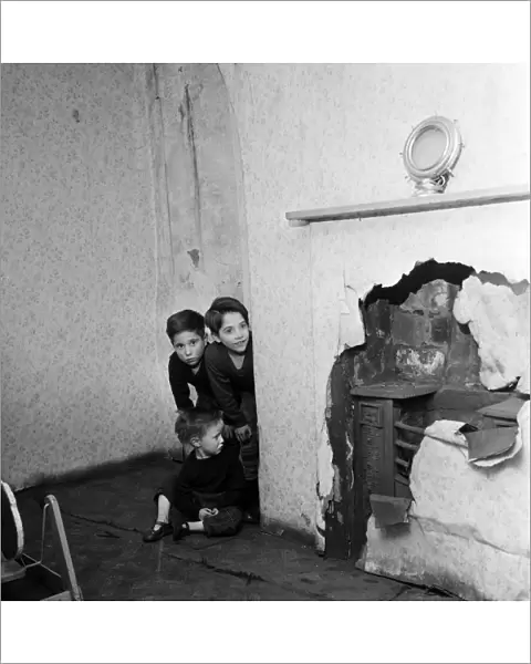 Slum housing in Salford. Brothers of the Logan family, Thomas, 9, John, 3, and Peter 7