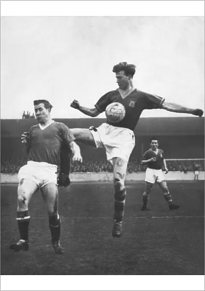 Bobby Charlton (left for Manchester United) in an action clash with his brother Jack