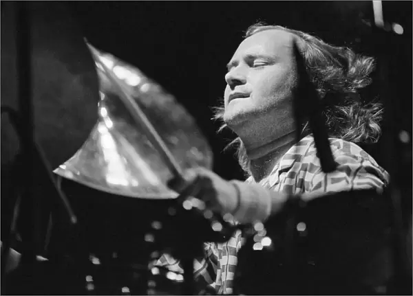 Phil Collins, drummer, actor, singer and songwriter, performing as drummer for his long
