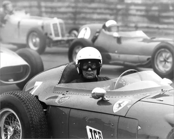 Stirling Moss sitting in Ferrari Dino racing car at Historic Car Championship Race at