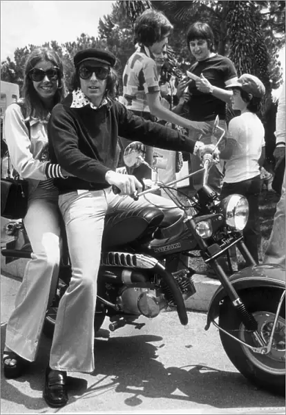 JACKIE STEWART AND WIFE HELEN ON A MOTOR BIKE AFTER HIS MONACO GRAND PRIX VICTORY JUNE