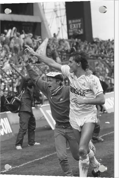 Glenn Hoddle running with a fan on the pitch after the match