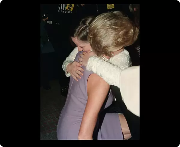 Princess Diana, wearing a purple dress, hugs Emma Jones at a Commonwealth Day luncheon in