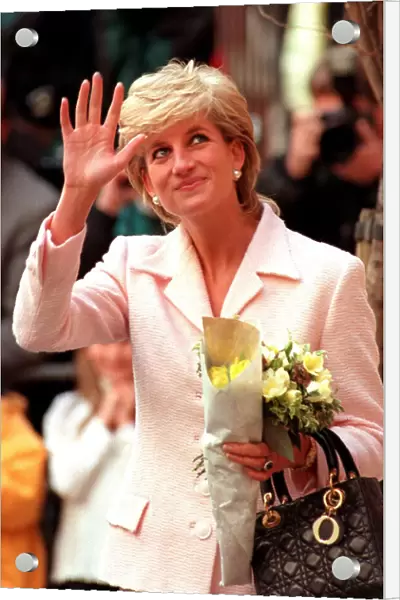 PRINCESS DIANA WEARING WHITE JACKET AND CARRYING FLOWERS LEAVES A LONDON ENGAGEMENT IN