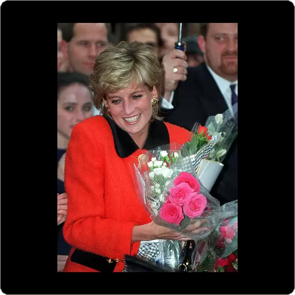 PRINCESS DIANA WEARS A RED SUIT, SMILES AND CARRIES FLOWERS DURING A VISIT TO THE ENGLISH