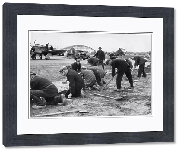 Dutch workmen help repair a dispersal at Volkel, Holland