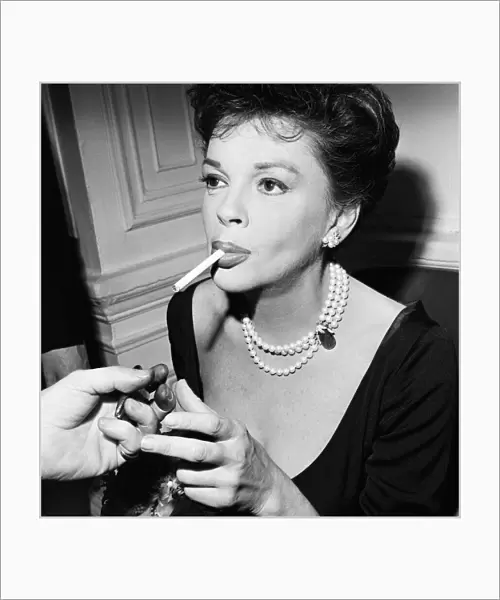 Judy Garland lighting a cigarette. 1963