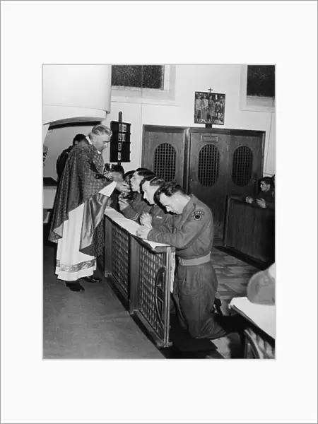Father Devine with the British 7th Armoured Division, holds mass in a Roman Catholic