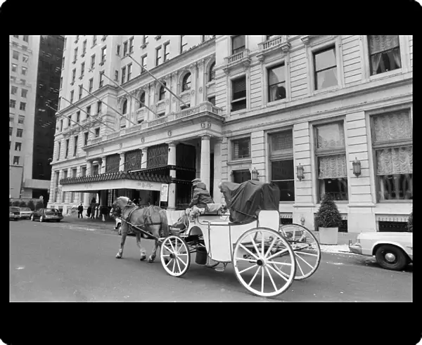 A horse drawn carriage riding past The Plaza Hotel. New York, 13th February 1981