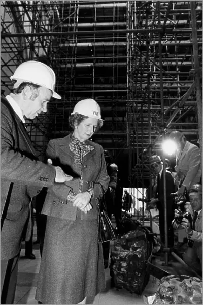 Margaret Thatcher wearing hard hat during visit to York Minster after storm damage