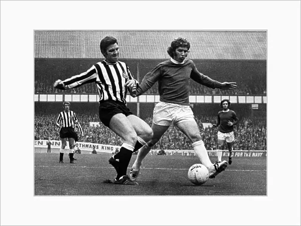 Ollie Burton of Newcastle United tries to tackle Alan Ball of Everton during their match