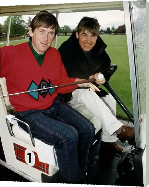 Kenny Dalglish and Stephen Hendry at golf course in golf cart holding club