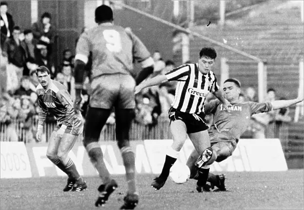 Paul Gascoigne of Newcastle United challenged for the ball by Vinnie Jones of Wimbledon