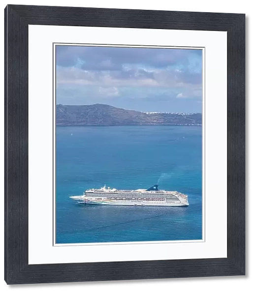 10.05.19. - Santorini, Greece: Norwegian Jade cruise ship in Santorini sea bay, Blue water with volcanic cliffs over the horizon. Luxury cruiser Fira