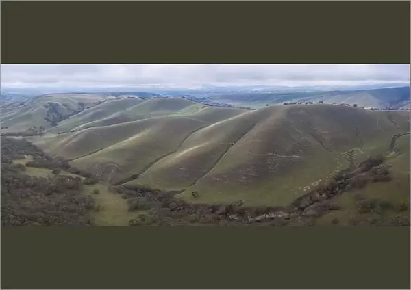 Clouds drift across peaceful green hills and valleys in the tri-valley area in Northern California
