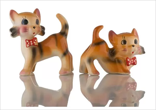 A pair of china kittens with red spotted bow ties