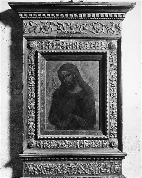Wooden frame with vine branches and geometric designs encircling a panel with the figure of Christ, in the Church of San Zaccaria in Venice