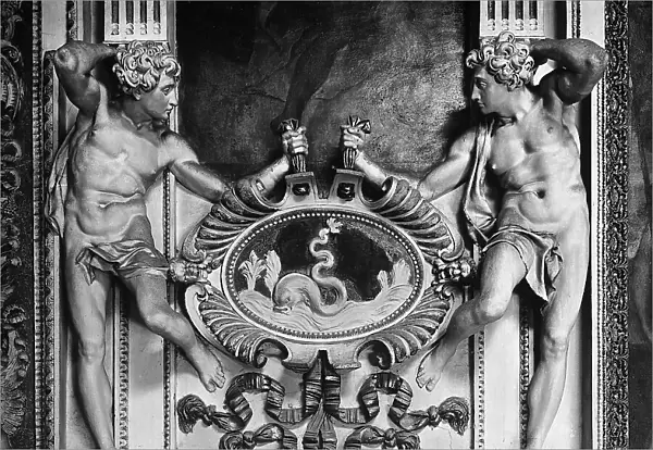 Two figures depicted in high relief holding up a medallion, detail of the stucco corridor by Mazzoni in Palazzo Spada, Rome