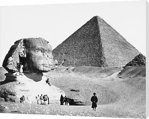 A group of Egyptians in Giza, photographed with the Sphinx. The pyramid of the pharoah of Cheops is in the background