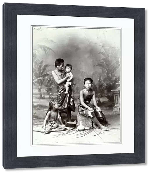 Two young women with their children, photographed in a Siam forest