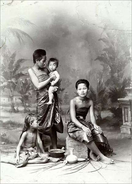 Two young women with their children, photographed in a Siam forest