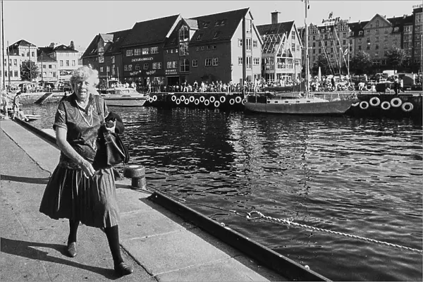 Lady strolling on the wharf of Bergen in Norway