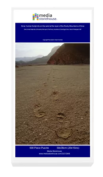 Sinai: human footprints on the sand at the layer of the Rocky Mountains of Sinai