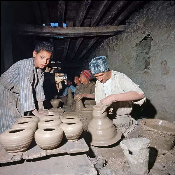 Upper Egypt: in a village along the banks of the Nile workers work the clay into a small factory