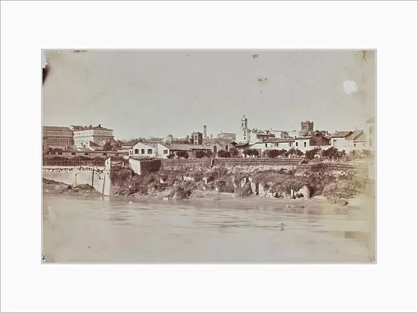 View of the right bank of the Tiber in Trastevere before the construction of the 'walls': from left the complex of San Michele, the bell tower of Santa Maria in the Chapel, the tobacco factory tower and the bell tower of the church of Santa Cecilia
