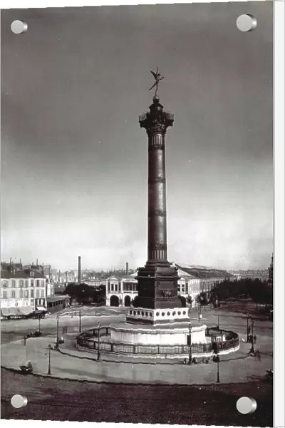 Place de la Bastille in Paris with the bronze Colonne de Juillet in the center. In the background, a tree-lined avenue flanked by tall buildings