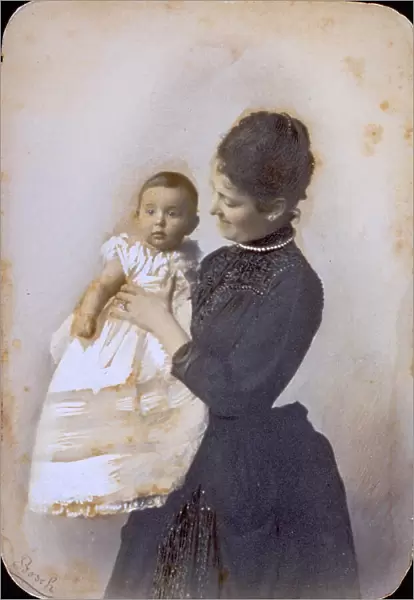Portrait of a lady holding her baby boy