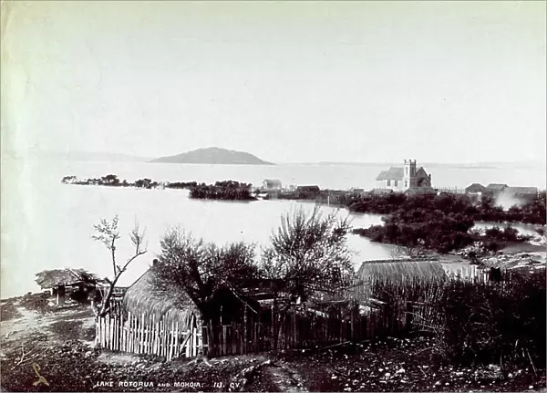 The shores of lake Taupo in Rotorua, New Zealand, with a few huts in the foreground